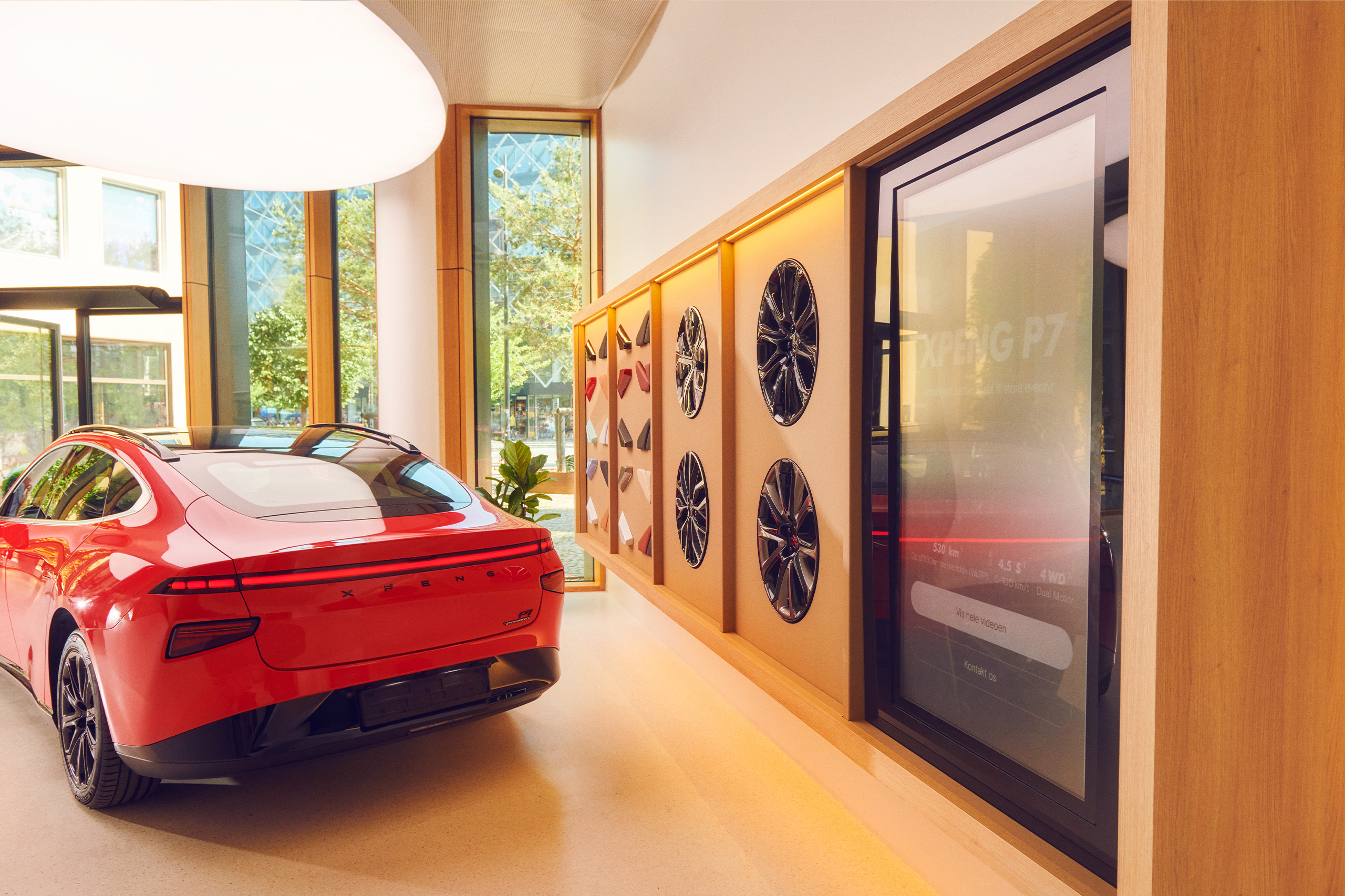 Red XPeng car with options wall